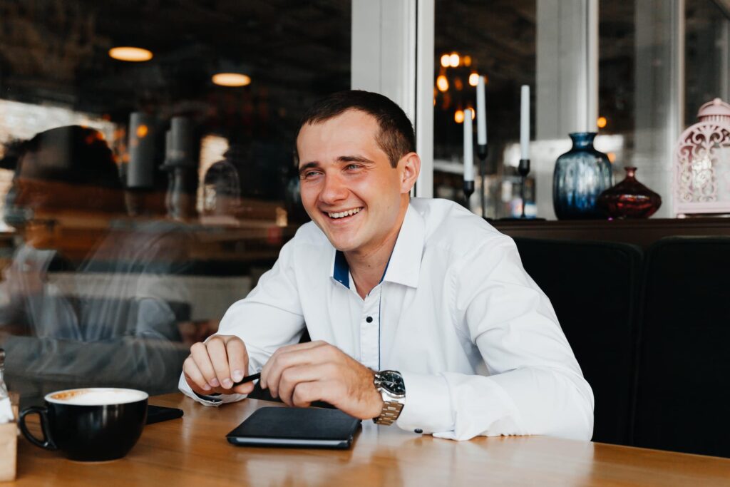 handsome-young-businessman-smiles-drinks-coffee-cafe-man-suit-with-coffee (1)